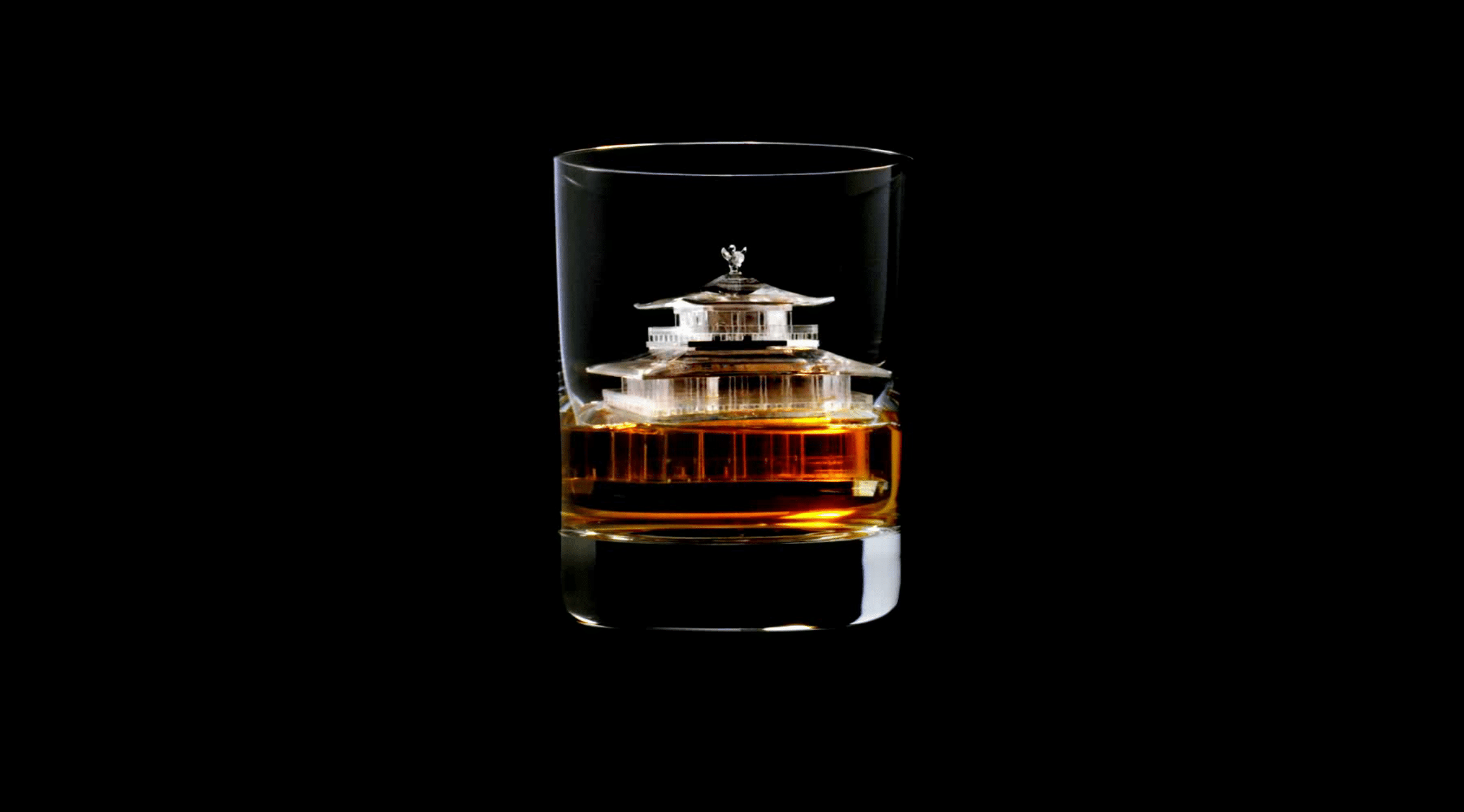 A whisky glass with a miniature ice sculpture of Kinkaku-ji