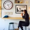 Woman seated at bench drinking coffee