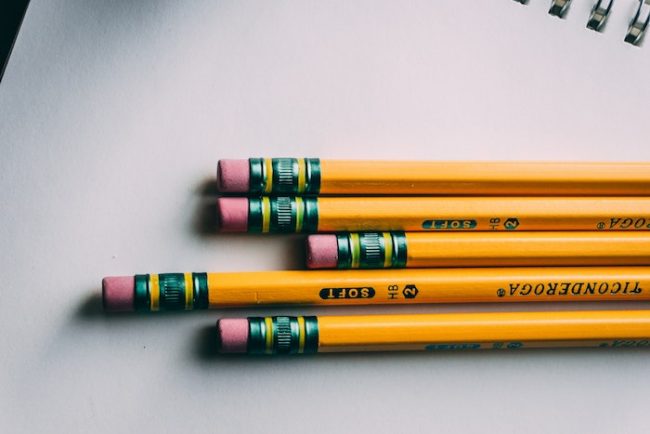 A stack of pencils with the eraser end on display