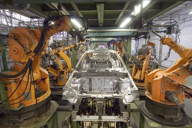 Kuka industrial robots working on a car