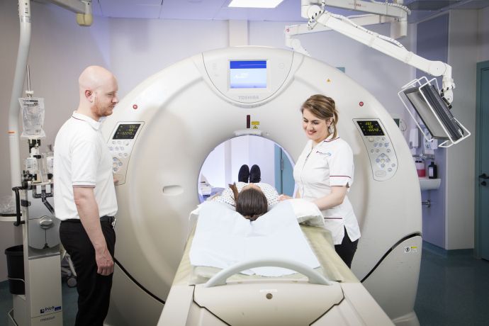 NHS Radiographers performing CT scan 